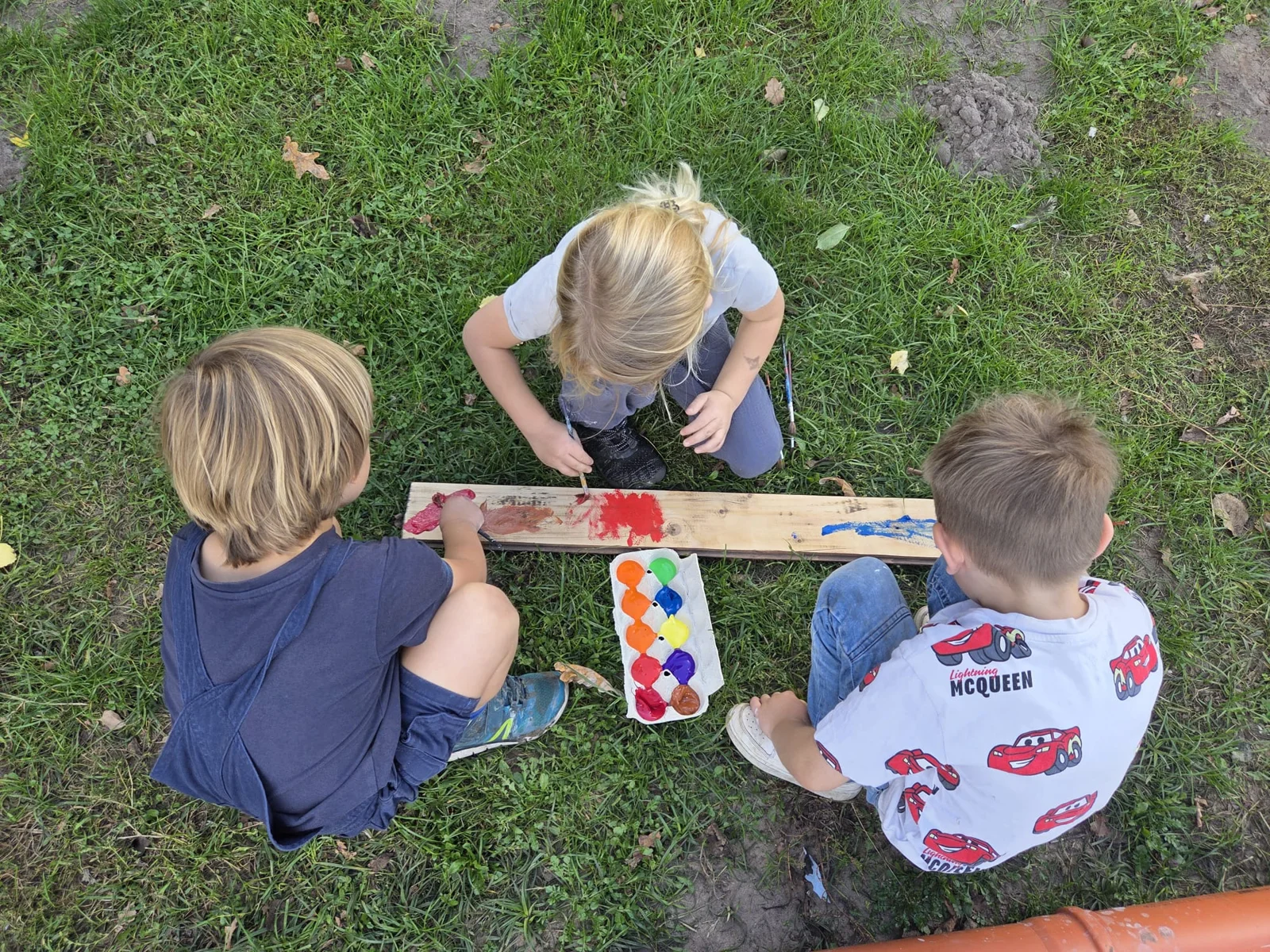 Kinder bemalen ein Brett